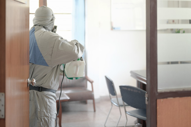 desinfeccion-oficina-prevenir-covid-19-persona-traje-blanco-materiales-peligrosos-desinfeccion-oficina-coronavirus